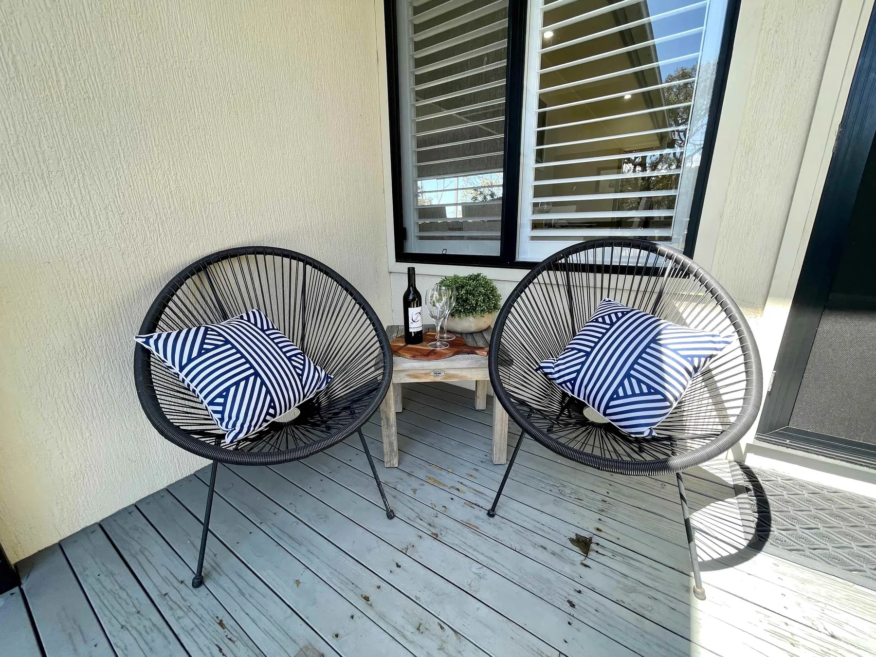 A small outdoor seating area with two chairs and a low table.