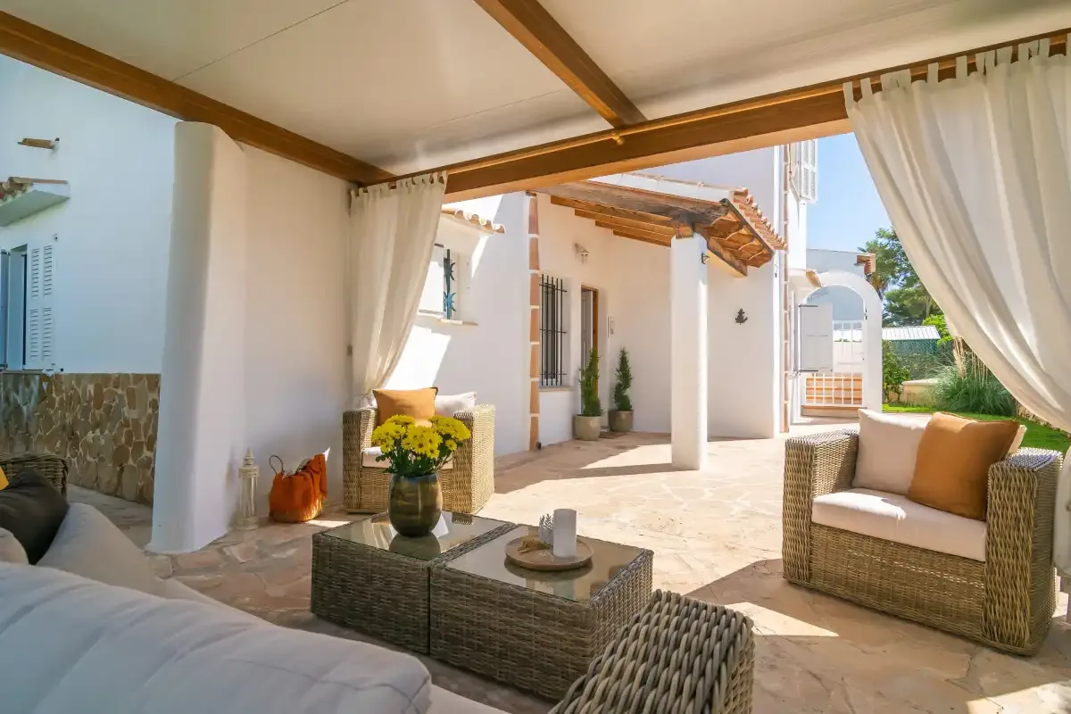 A bright patio seating area opens onto a sunlit courtyard.