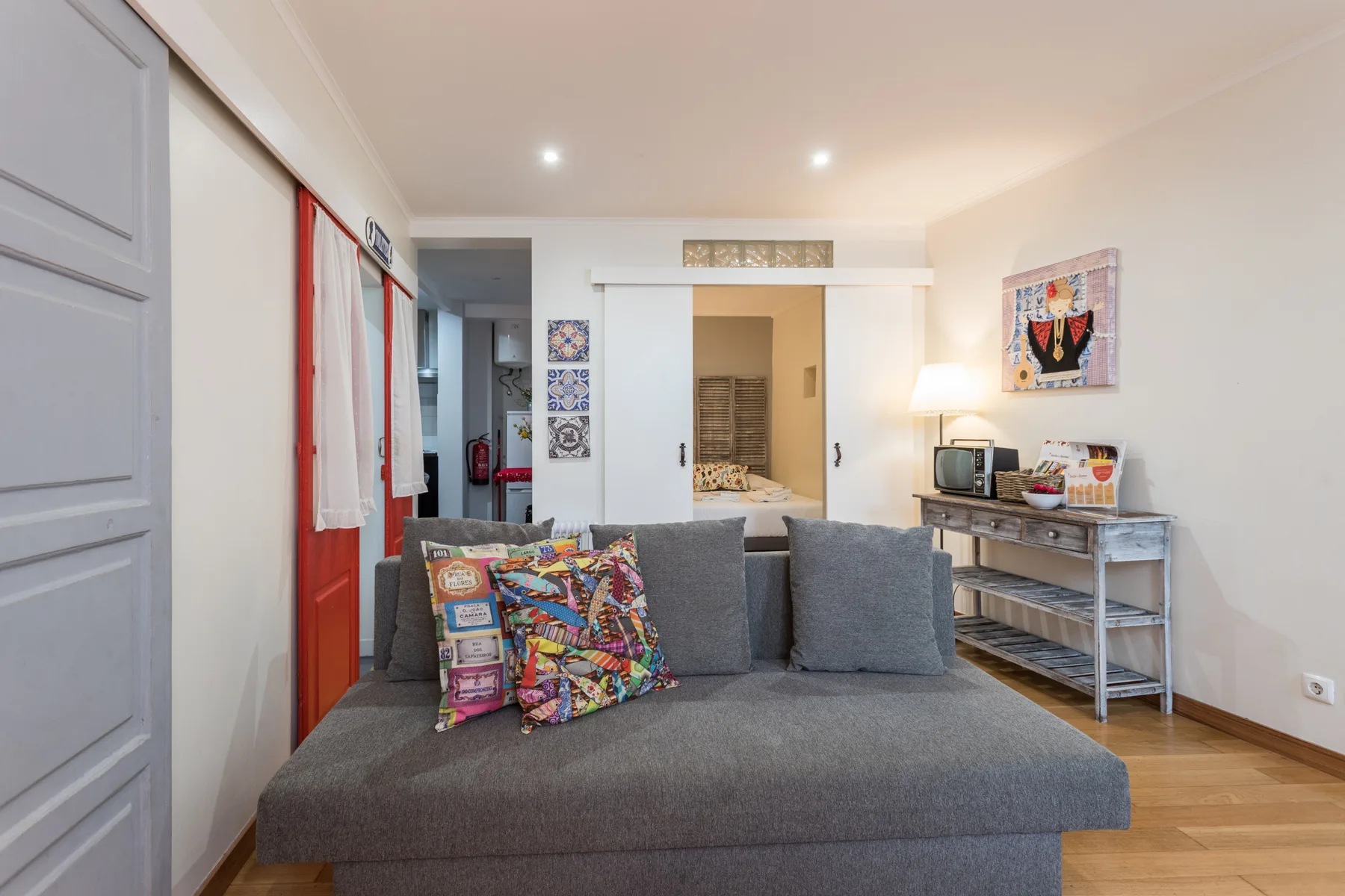 A living room with gray seating and a console table along the wall.