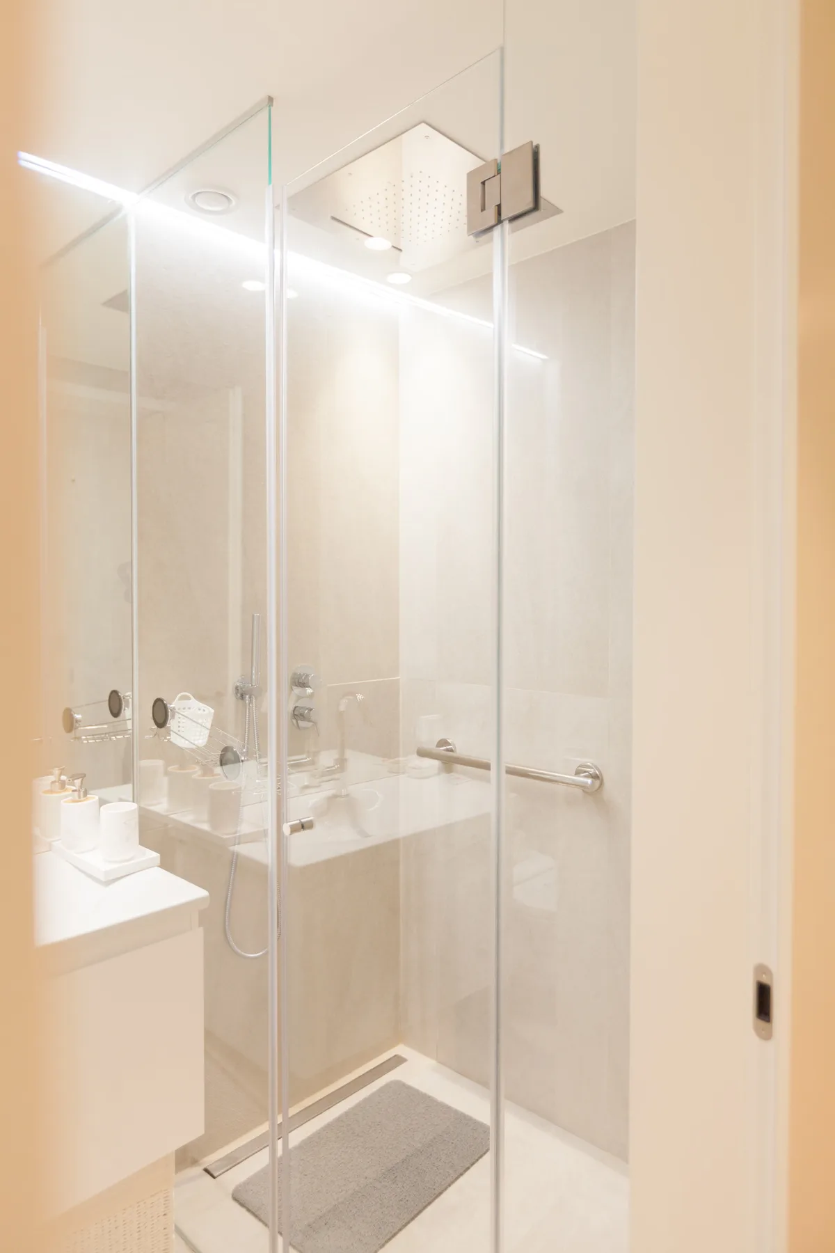 A bright bathroom with a glass shower and wall-mounted showerhead.