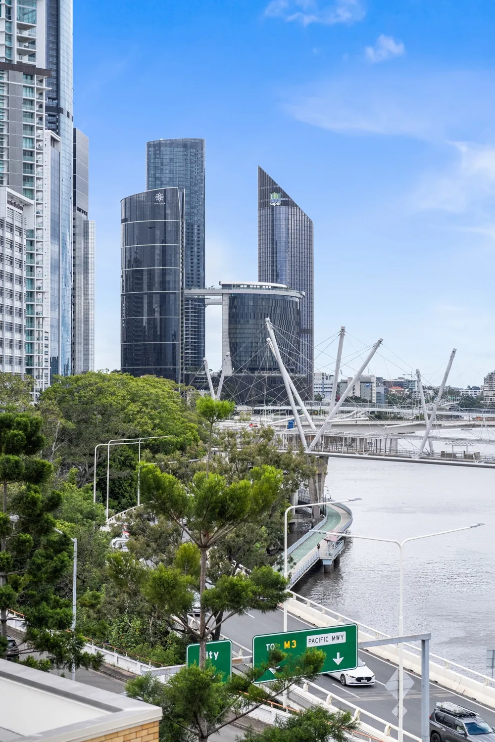 El horizonte urbano se alza junto a un río y un parque verde junto al agua.