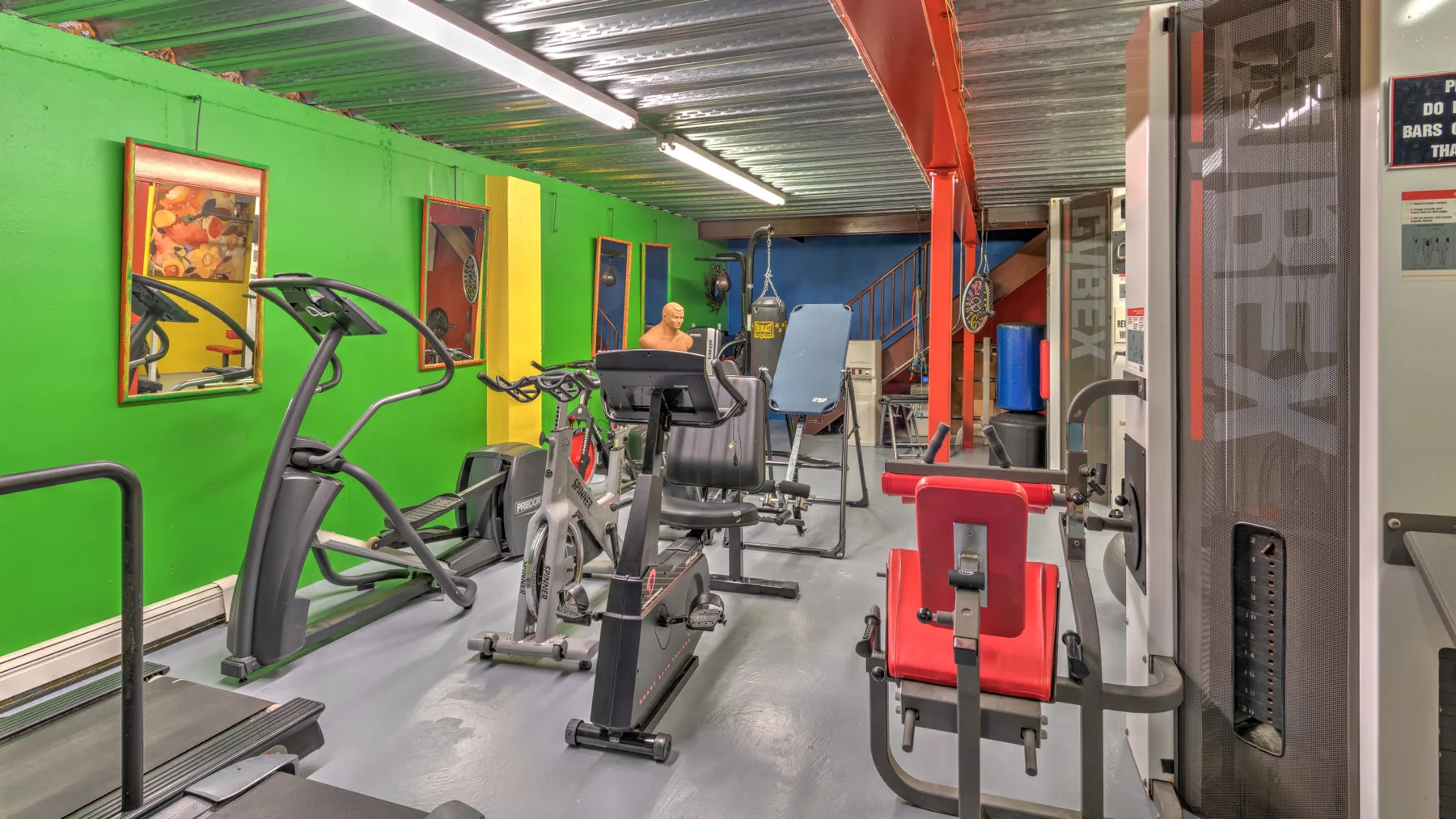 A gym with exercise machines and weight-training equipment.