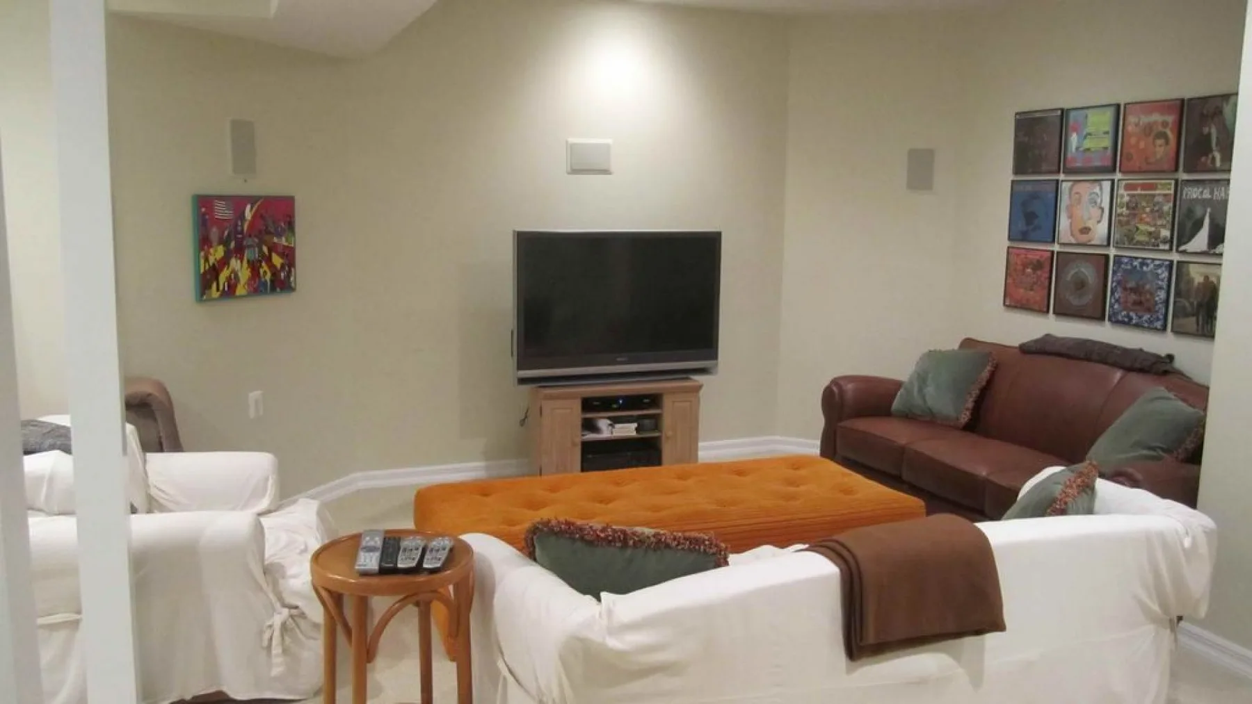 A living room with sofas and a television facing a low coffee table.