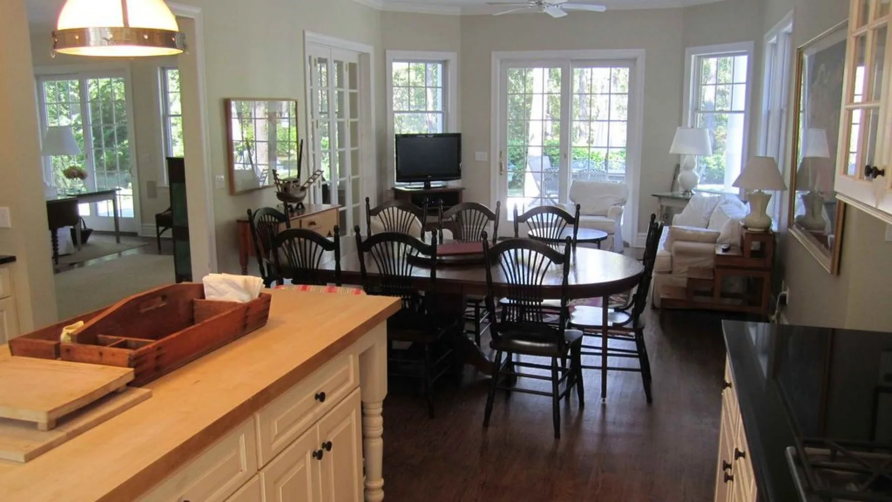 A dining area with a round table and chairs beside a kitchen counter.