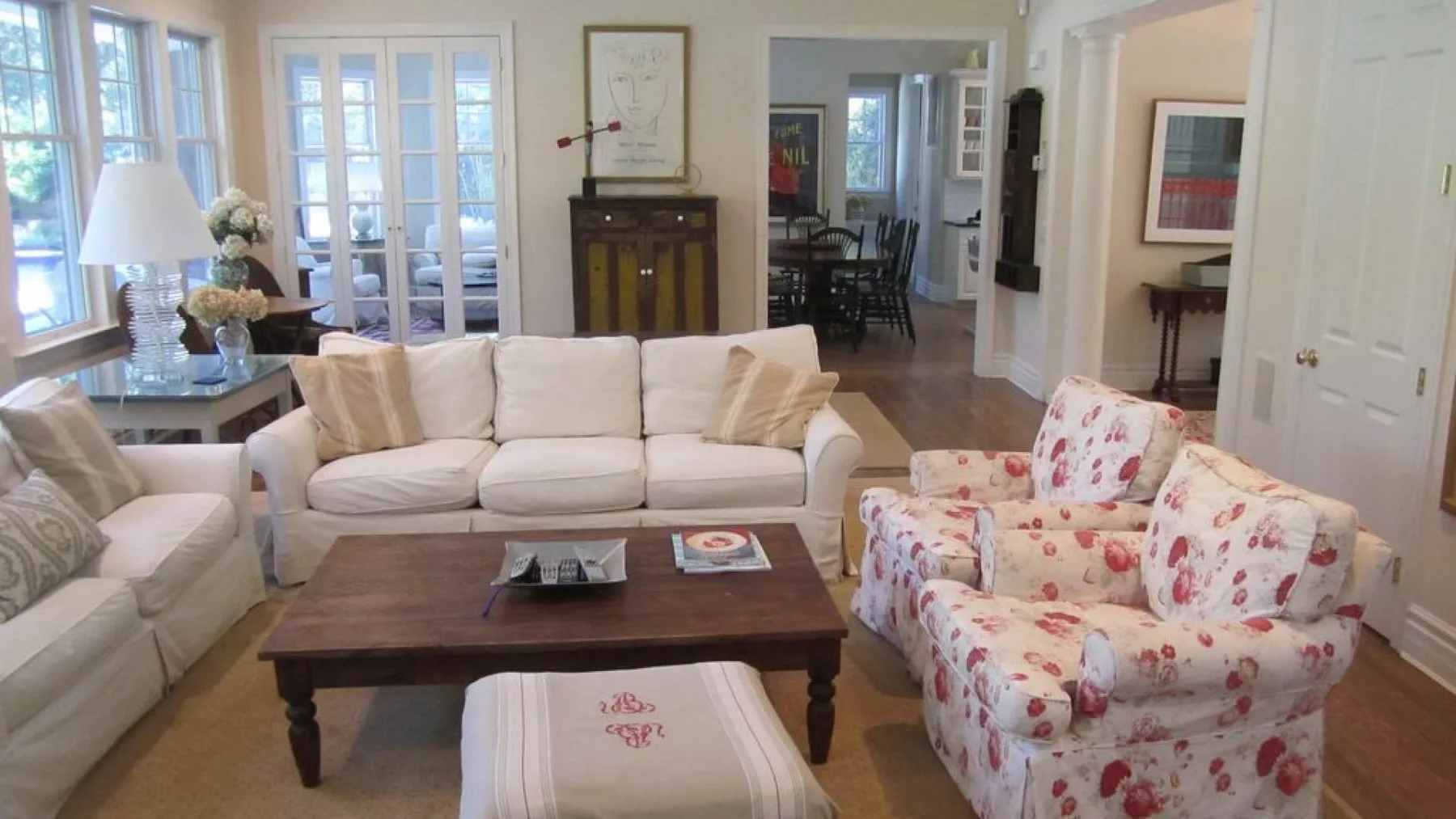 A bright living room with upholstered seating and a wooden coffee table.