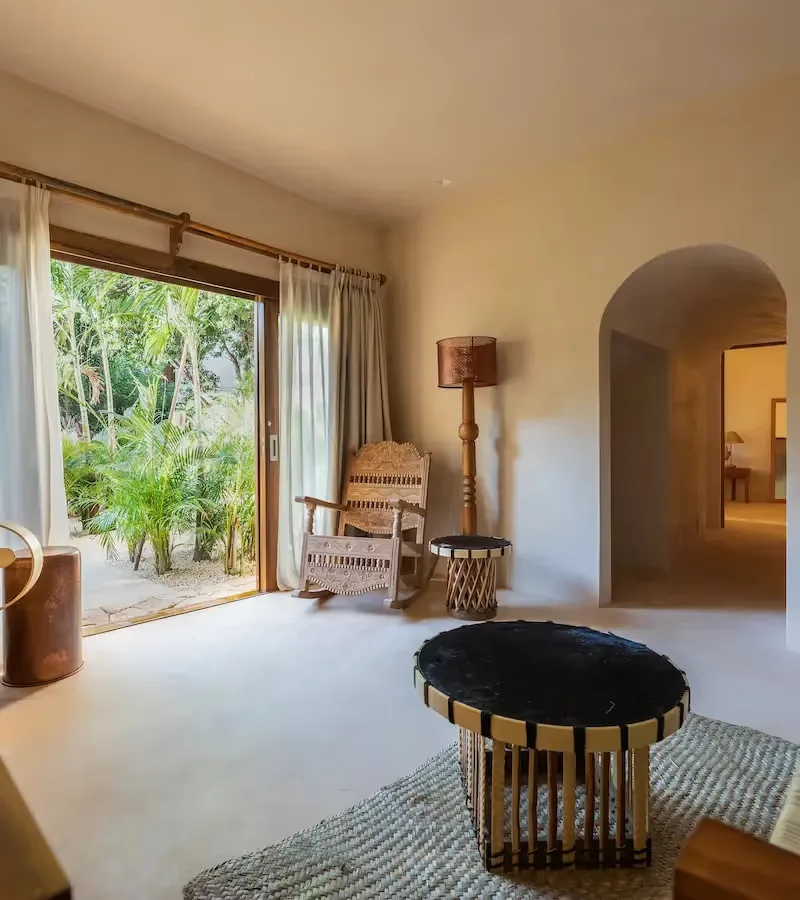 Suite living area opening onto a tropical terrace.