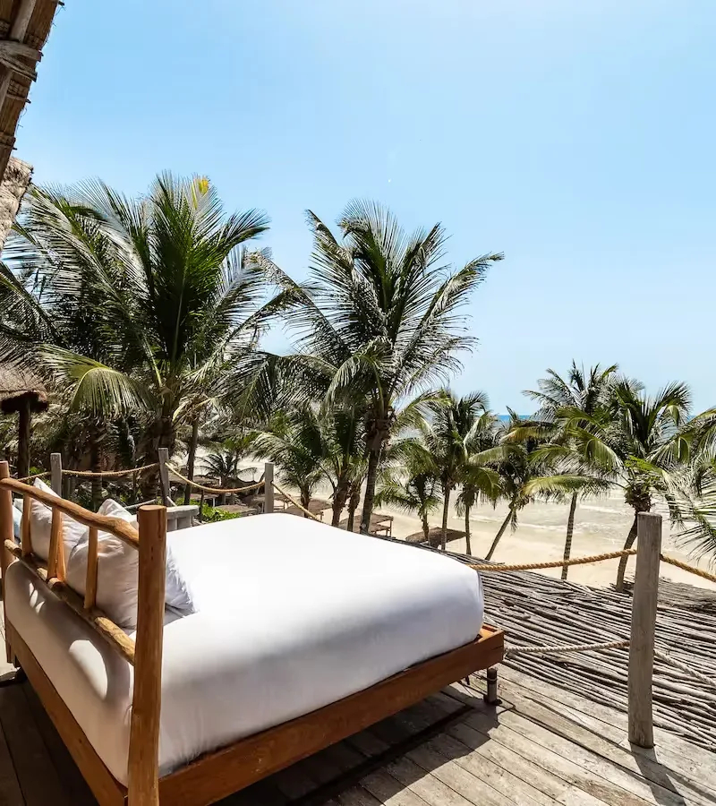 Bed set on a private terrace facing the beach.