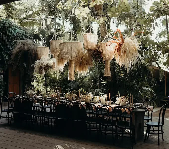 Long reception table beneath pendant lights.