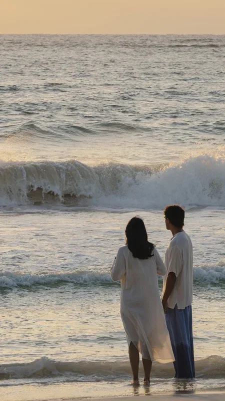 Couple silhouetted by a window at sunset.