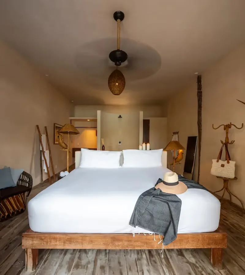Bedroom interior with wooden bed and ceiling fan.