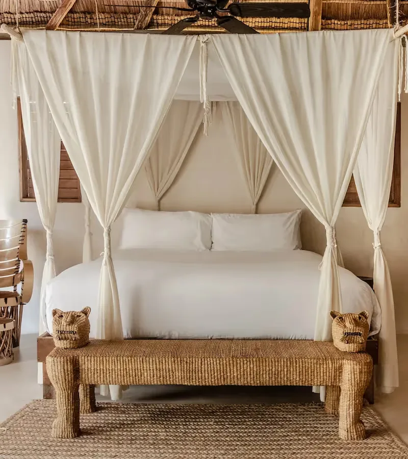 Bedroom with canopy bed and artisanal decor.