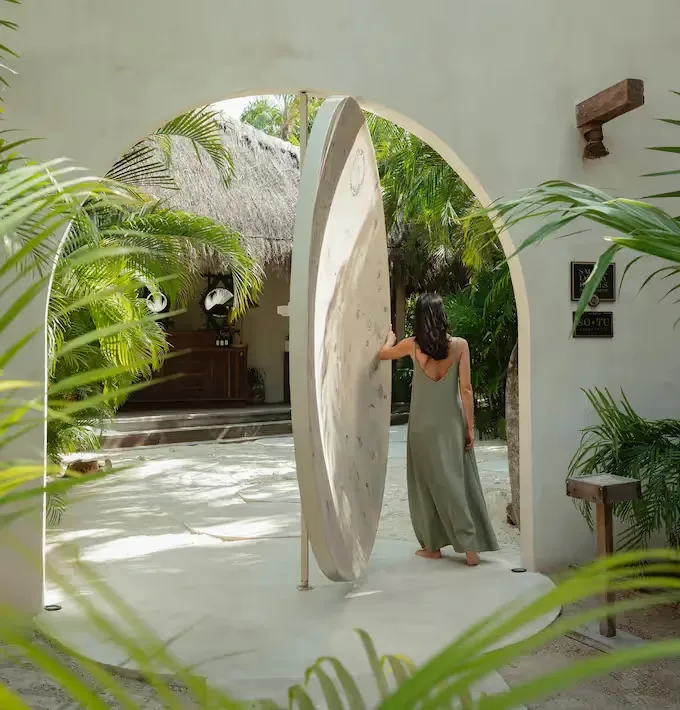 Minimalist entrance with a circular pivoting door.