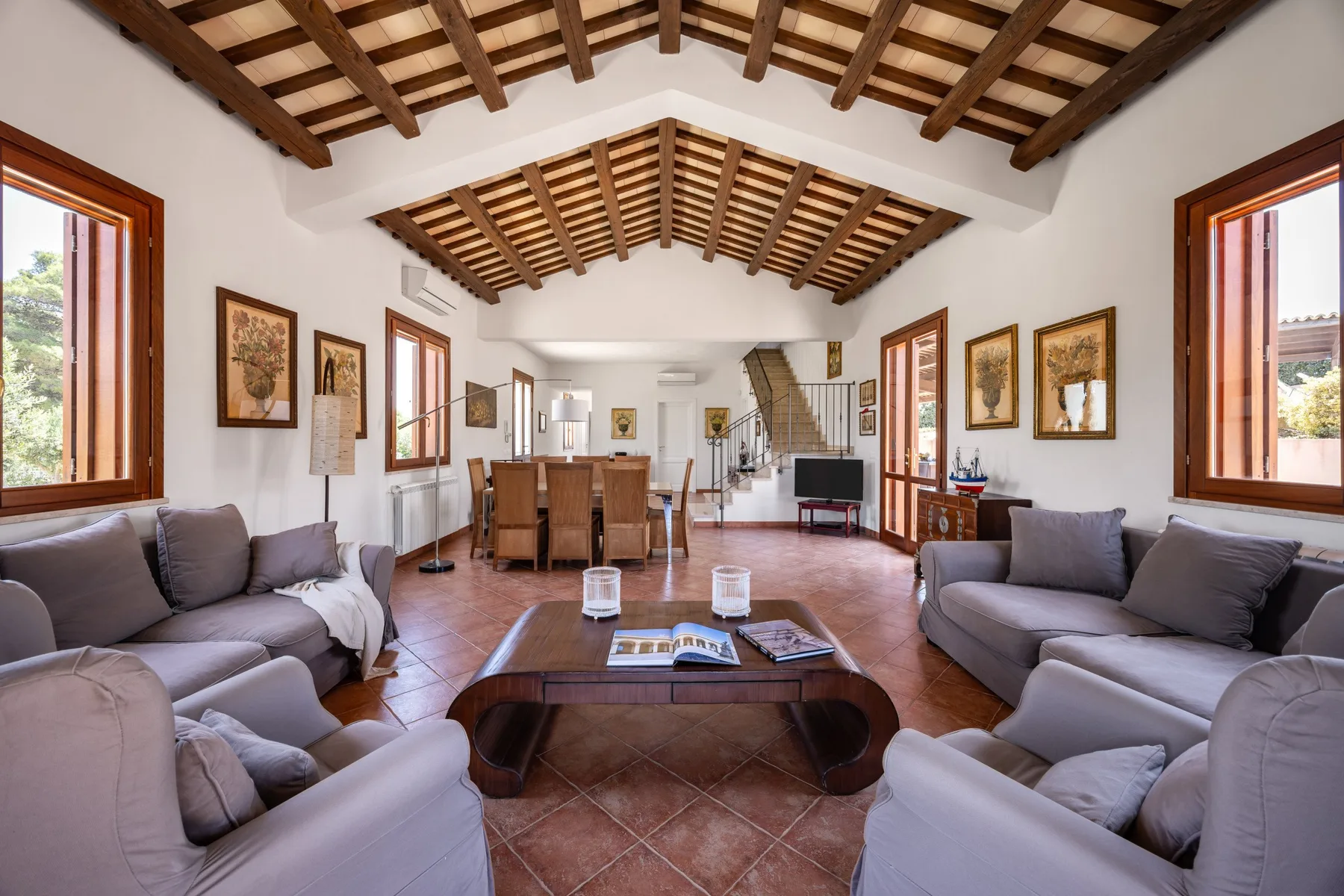 A spacious living room with seating around a central coffee table.