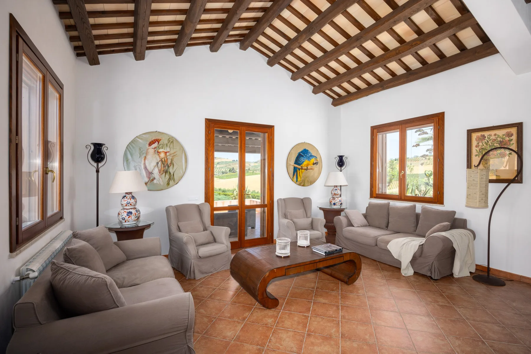 A living room with seating arranged around a wooden coffee table.
