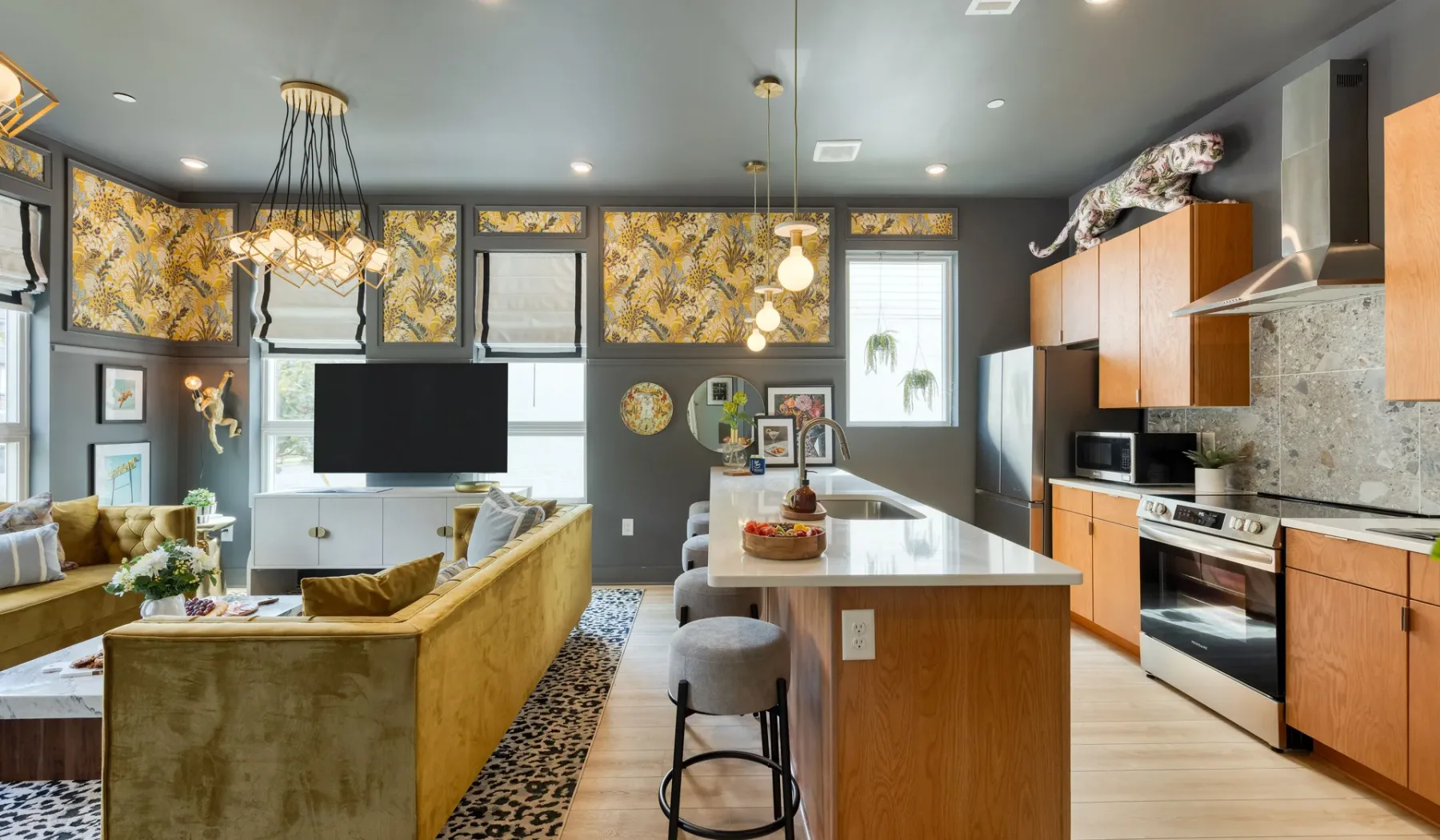 An open-plan kitchen and living area with a central island and seating.