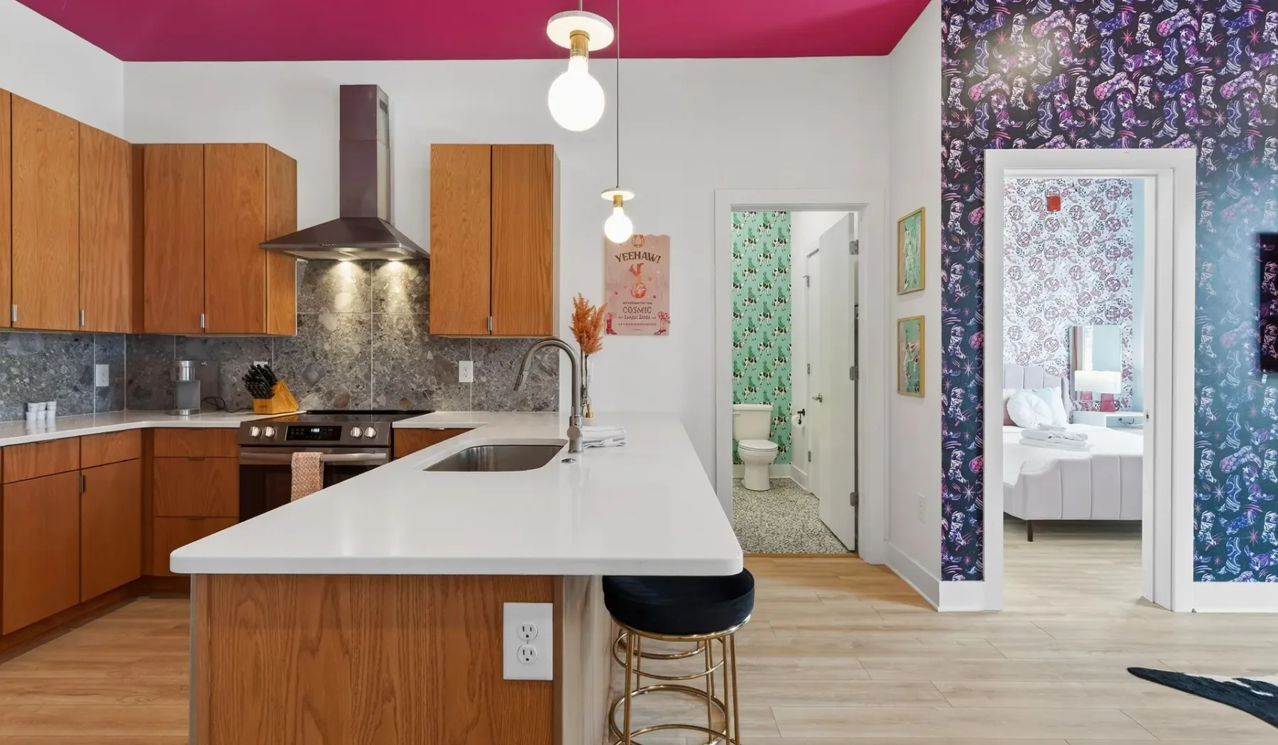 A kitchen with a white island and adjoining doorways.