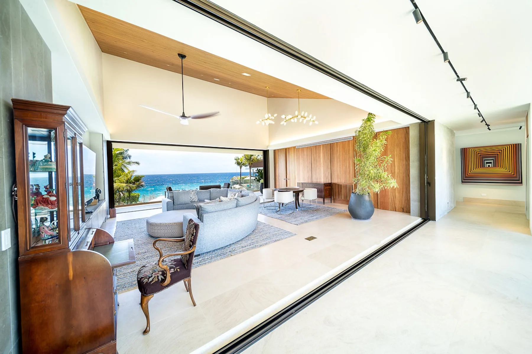 A bright living room opens onto a terrace with ocean views.