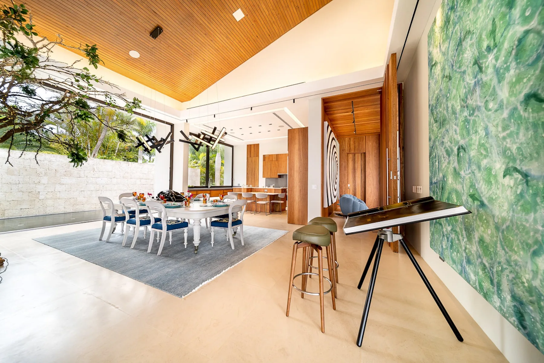 A dining area with a long table and a high wooden ceiling.