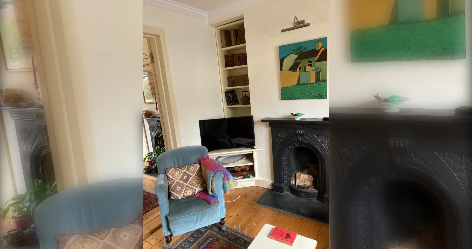A living room with an armchair, television, and fireplace.