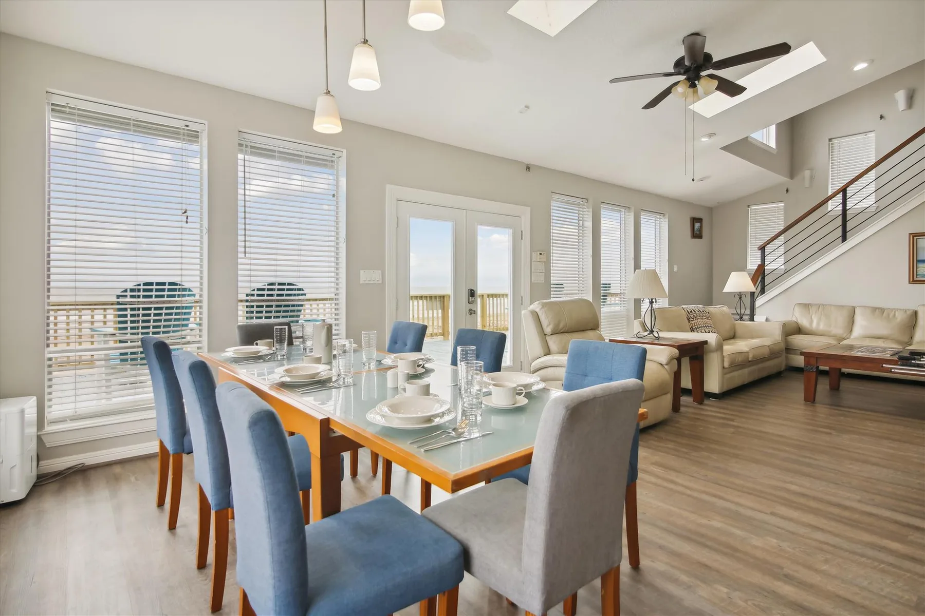 An open dining and living area features a set dining table and lounge seating.