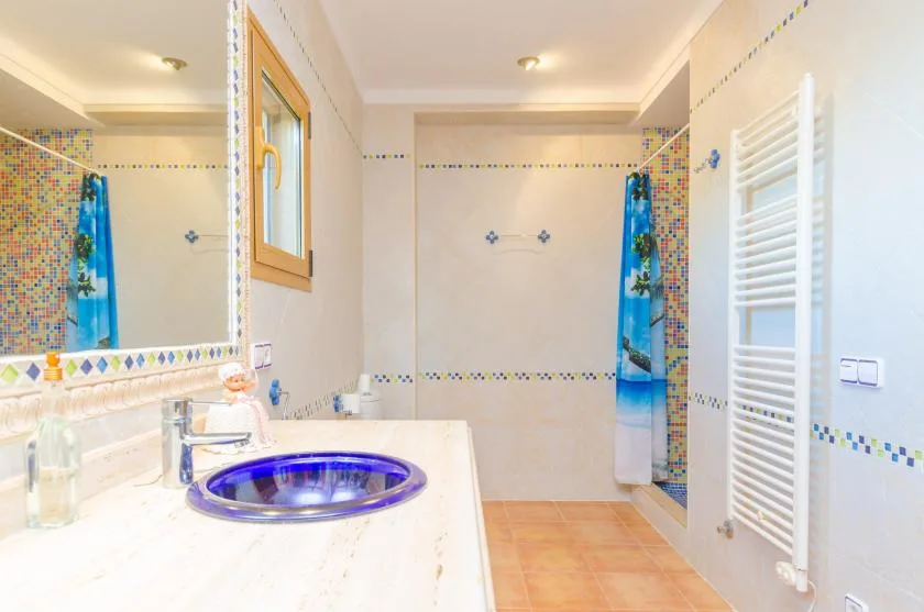 Bathroom with a blue basin set into a white countertop.