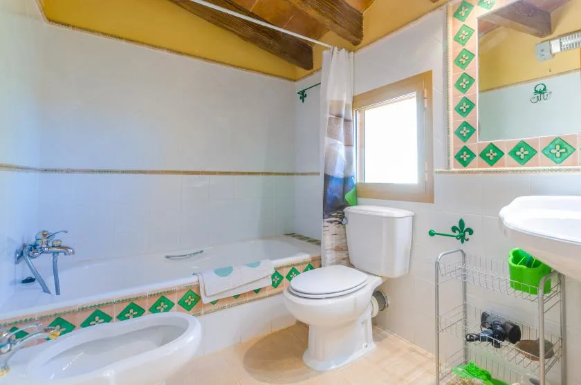 A bathroom with a bathtub, toilet, and sink.