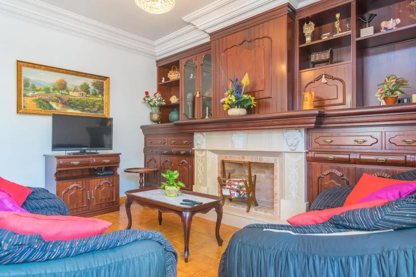 A living room with upholstered seating arranged around a coffee table and fireplace.