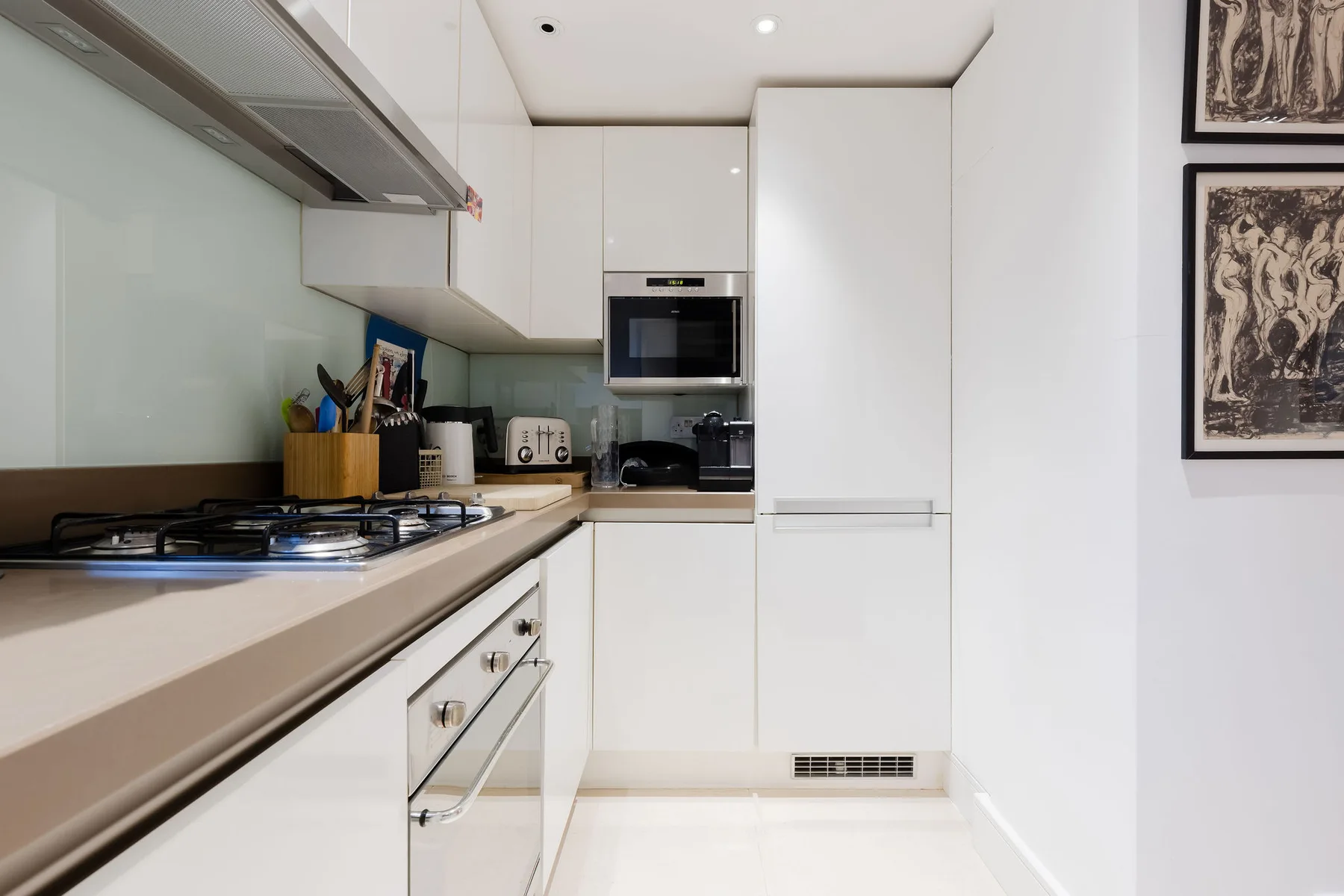 Una cocina moderna y luminosa con gabinetes blancos y una encimera.