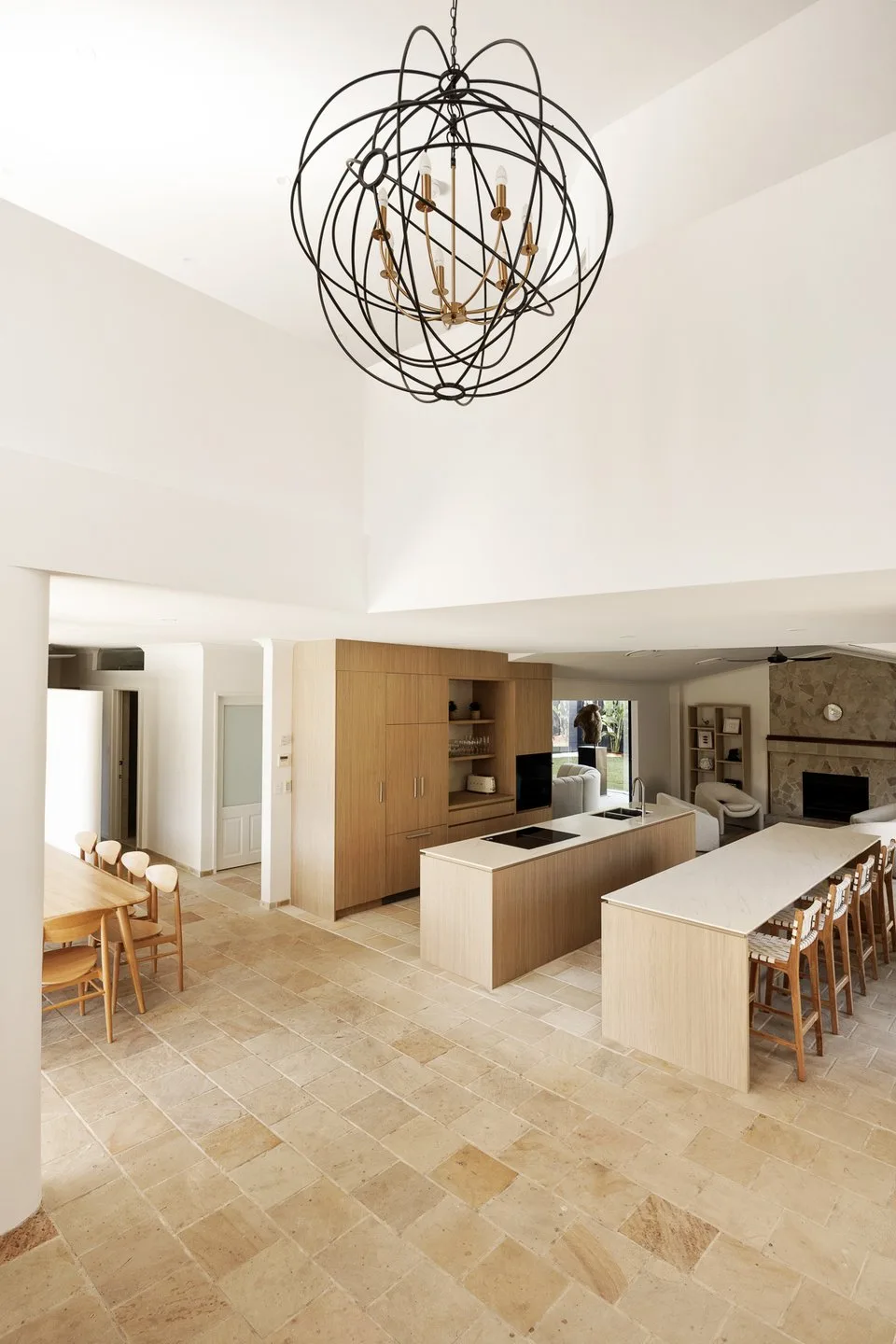 Open-plan kitchen and dining area with a large sculptural pendant light.