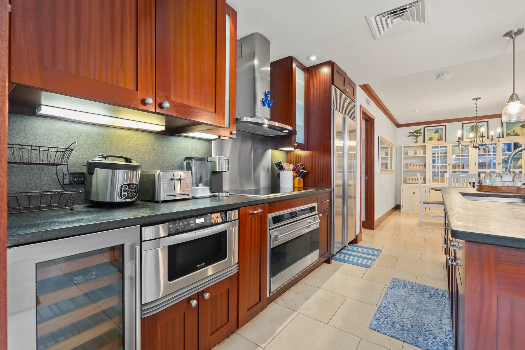 Una cocina moderna con gabinetes de madera y una encimera larga.