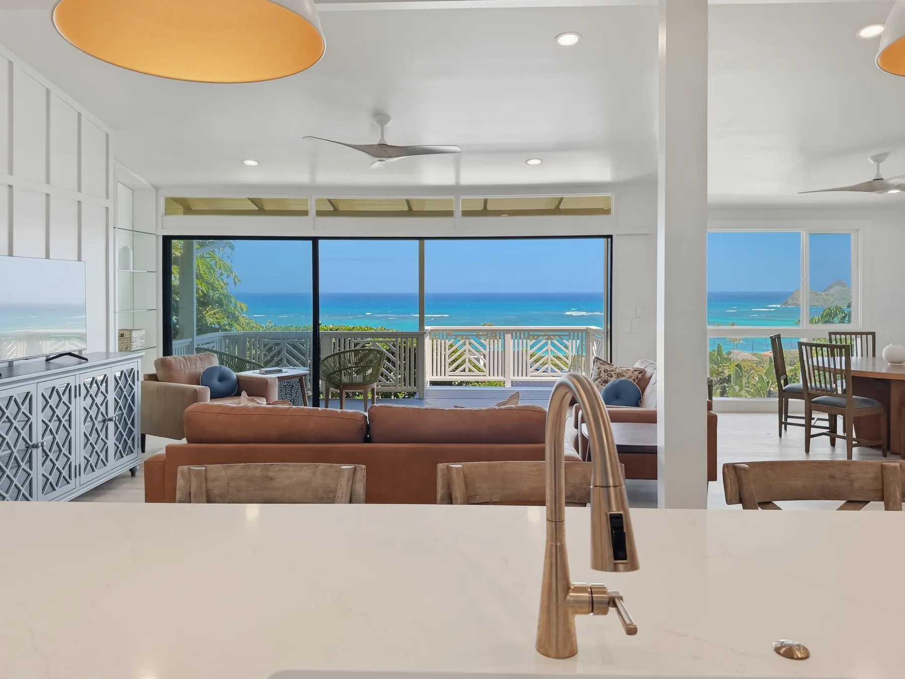 A bright open-plan living and dining area overlooks the ocean.