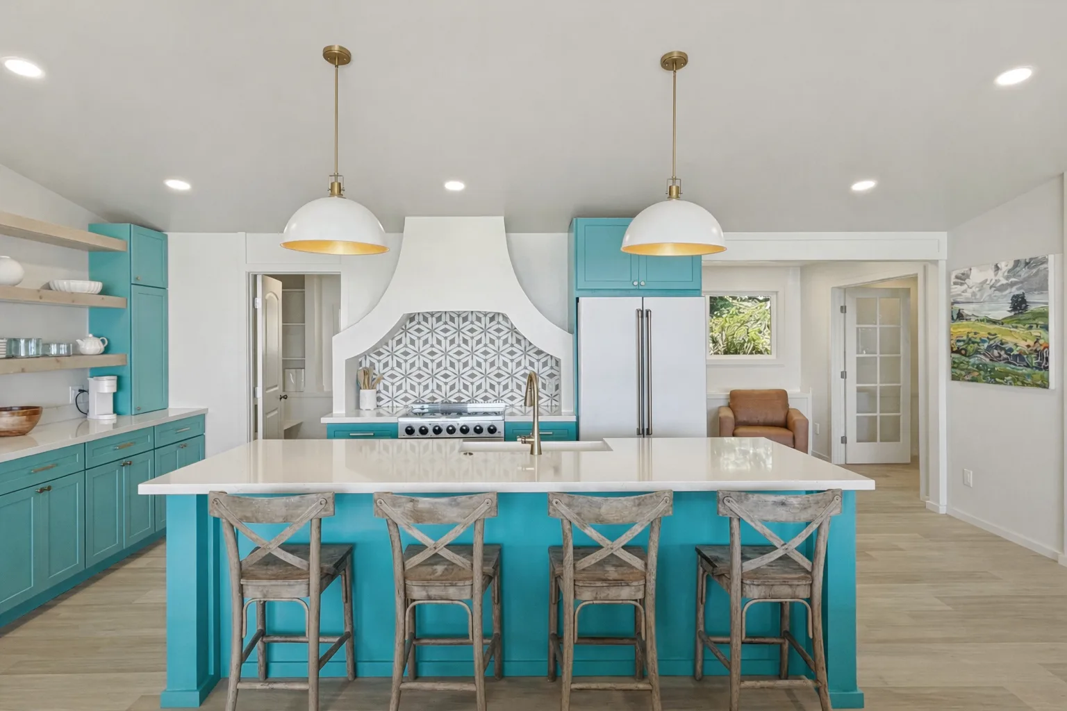 A bright kitchen features turquoise cabinets and a central island with seating.