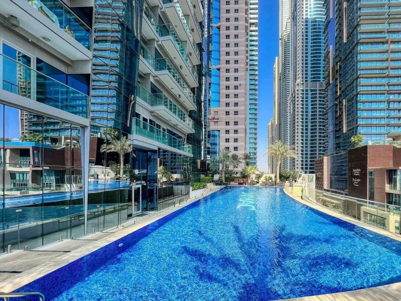 Una piscina está entre altos edificios residenciales modernos.