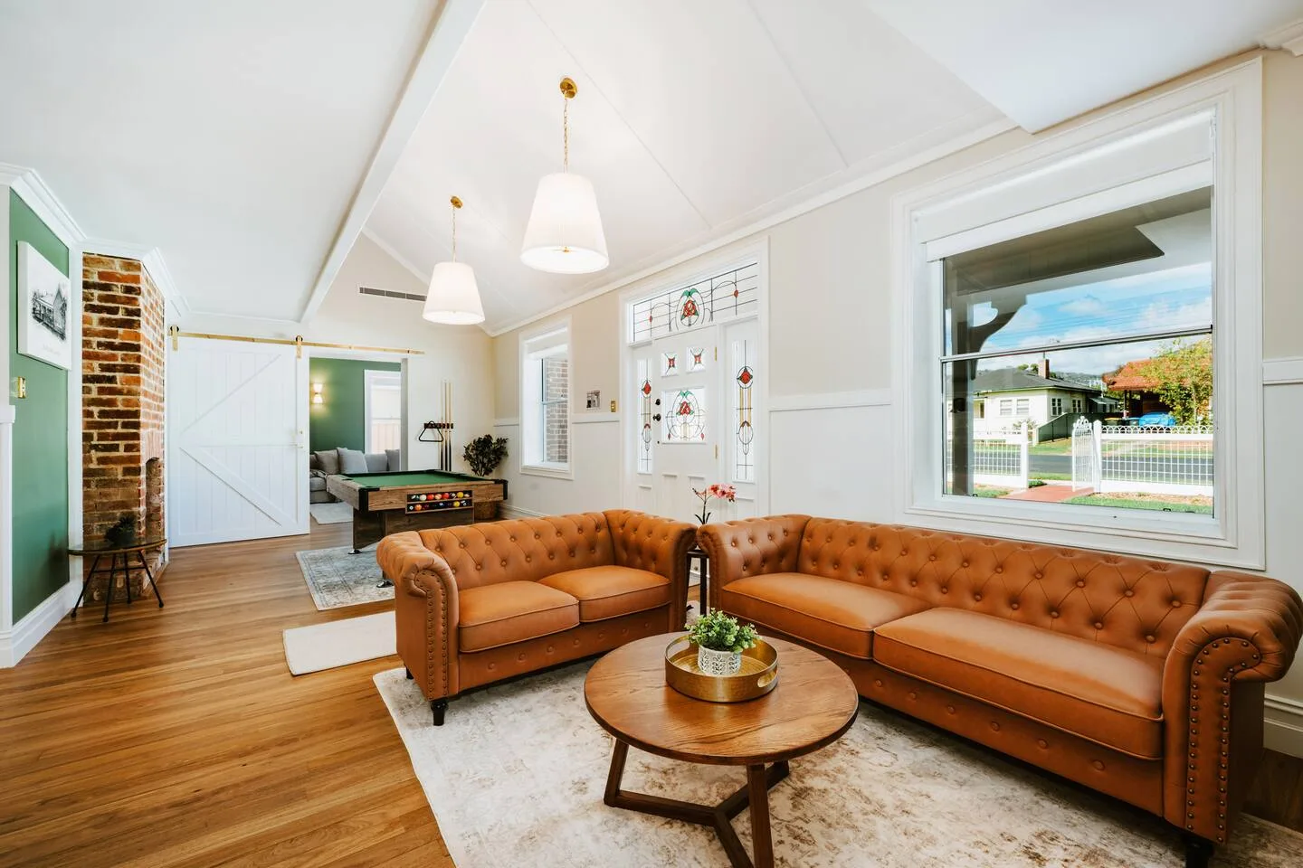 A living room with two brown sofas and a wooden coffee table.