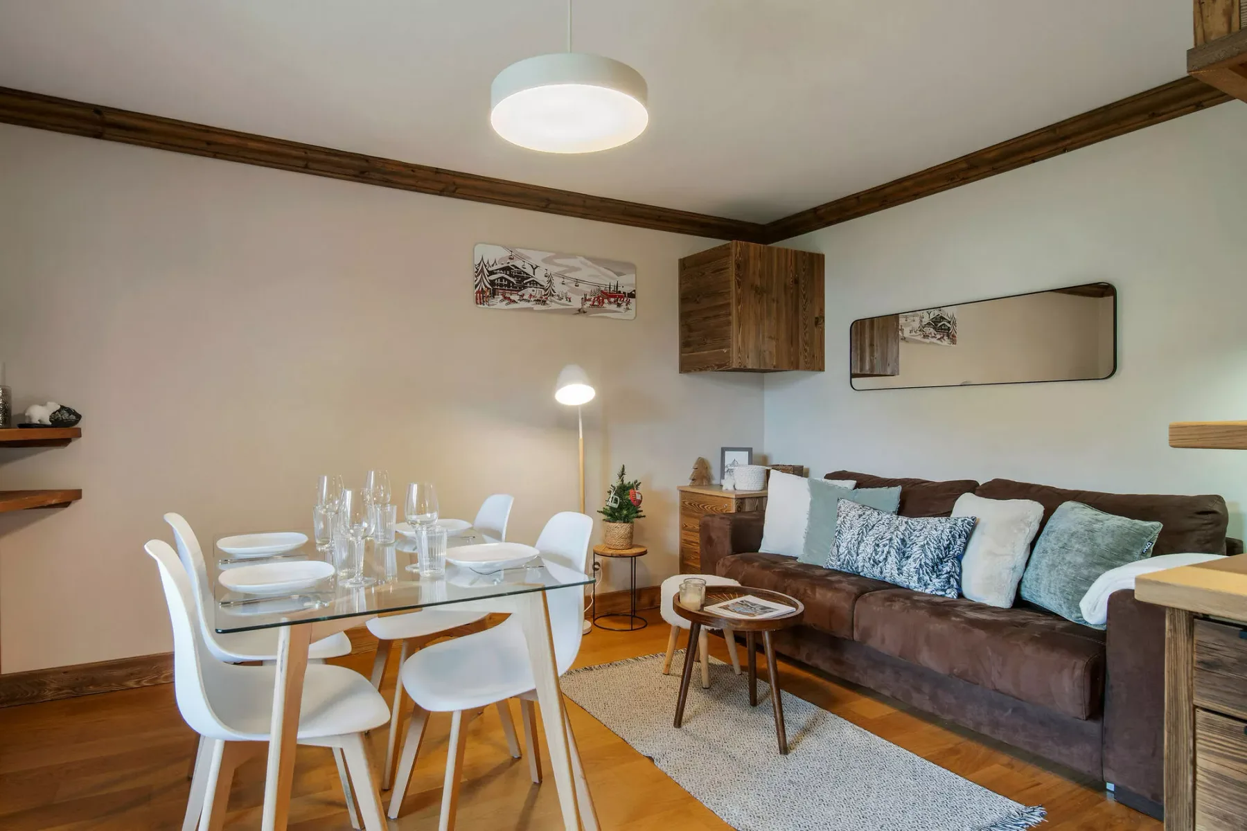 A dining and sitting area with a table, chairs, and a sofa.