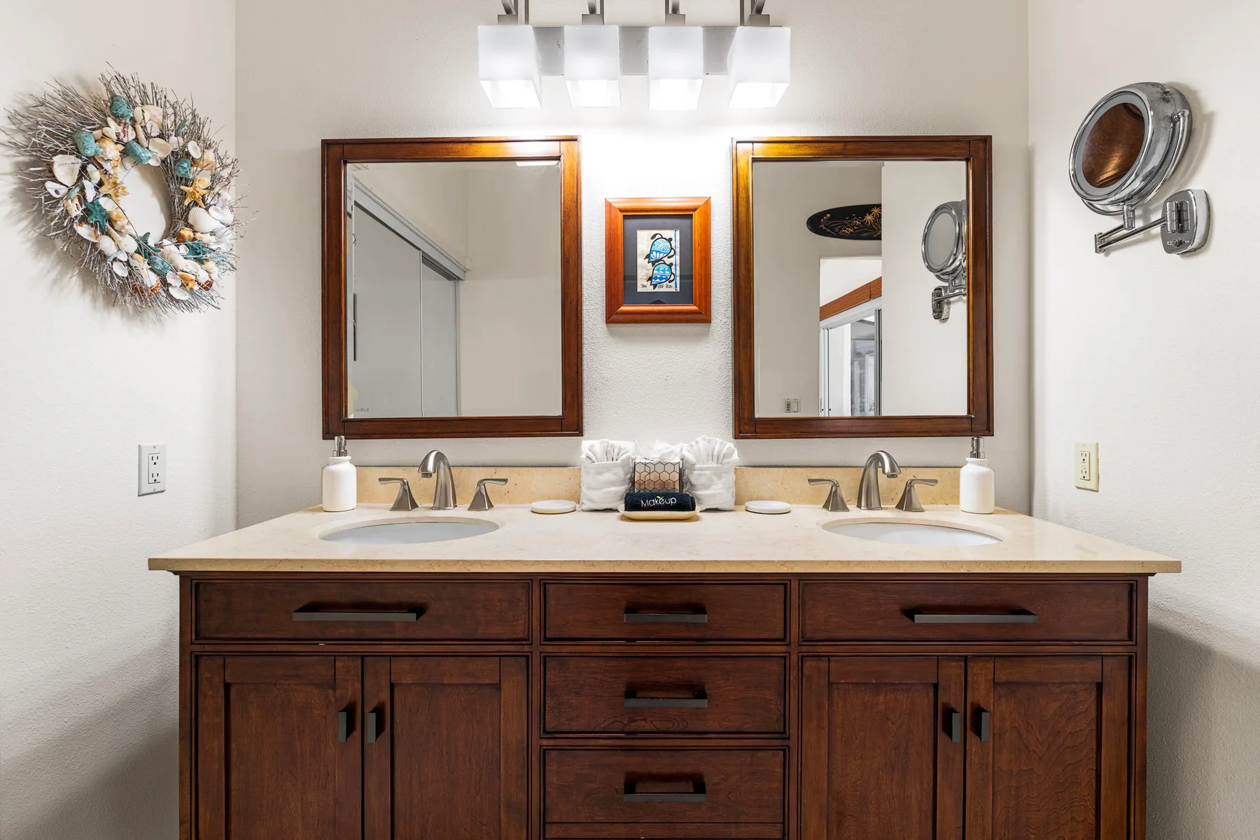 A bathroom vanity with two sinks and mirrors.