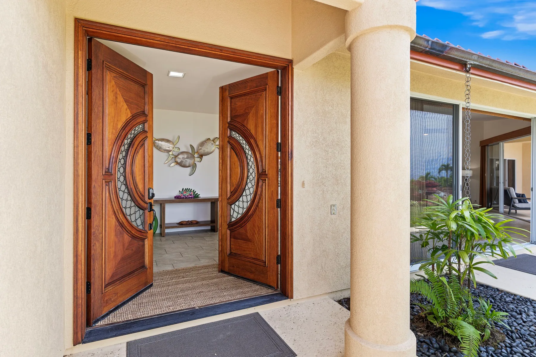 An open entryway with ornate wooden doors and a view into the interior.