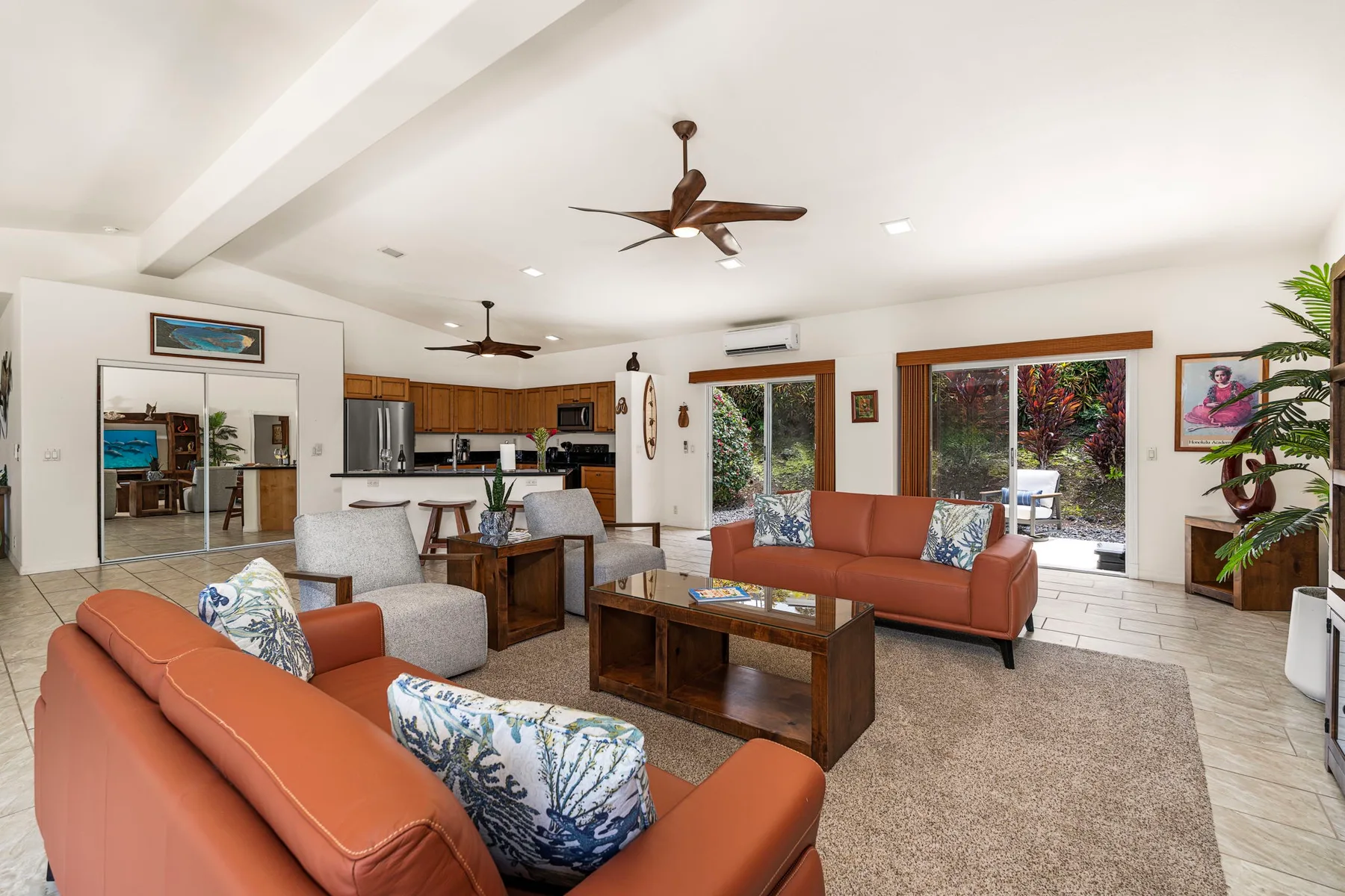 A bright living room with seating arranged around a wooden coffee table.