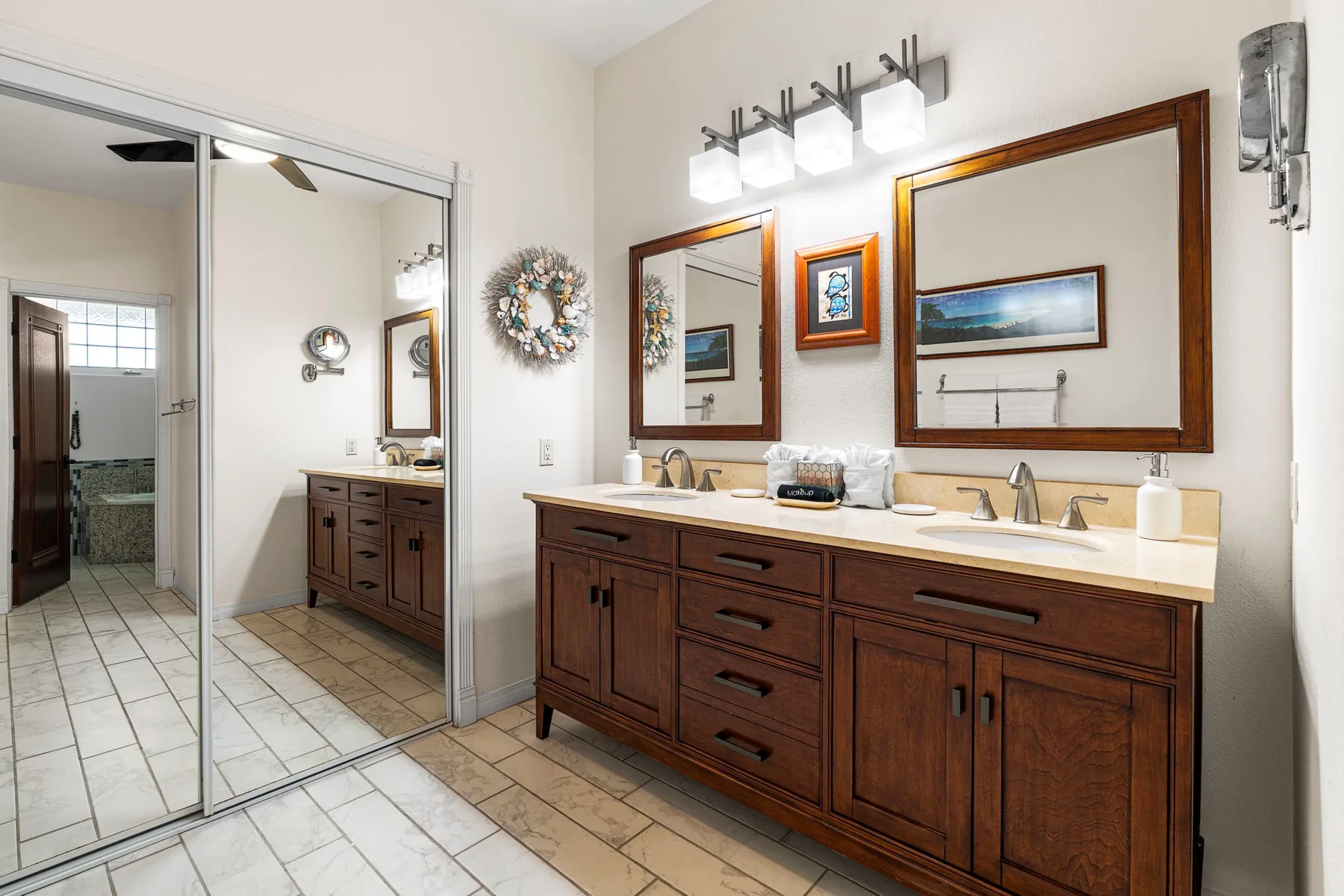 A bathroom vanity with twin sinks and a large wall mirror.