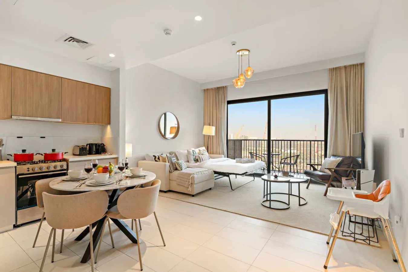 An open-plan living and dining area with a kitchen and large windows.