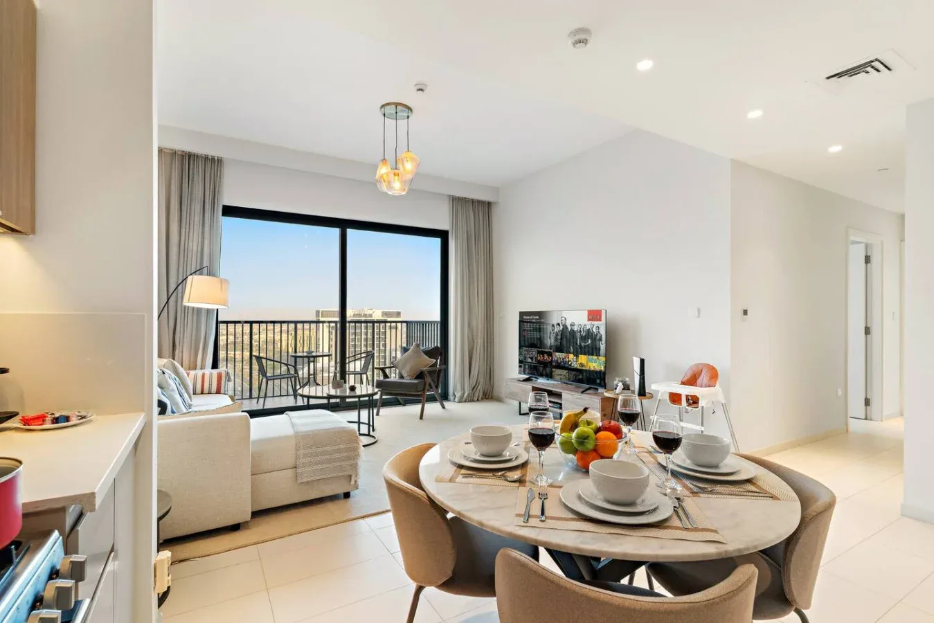 A bright open-plan living and dining area with a table beside the seating.