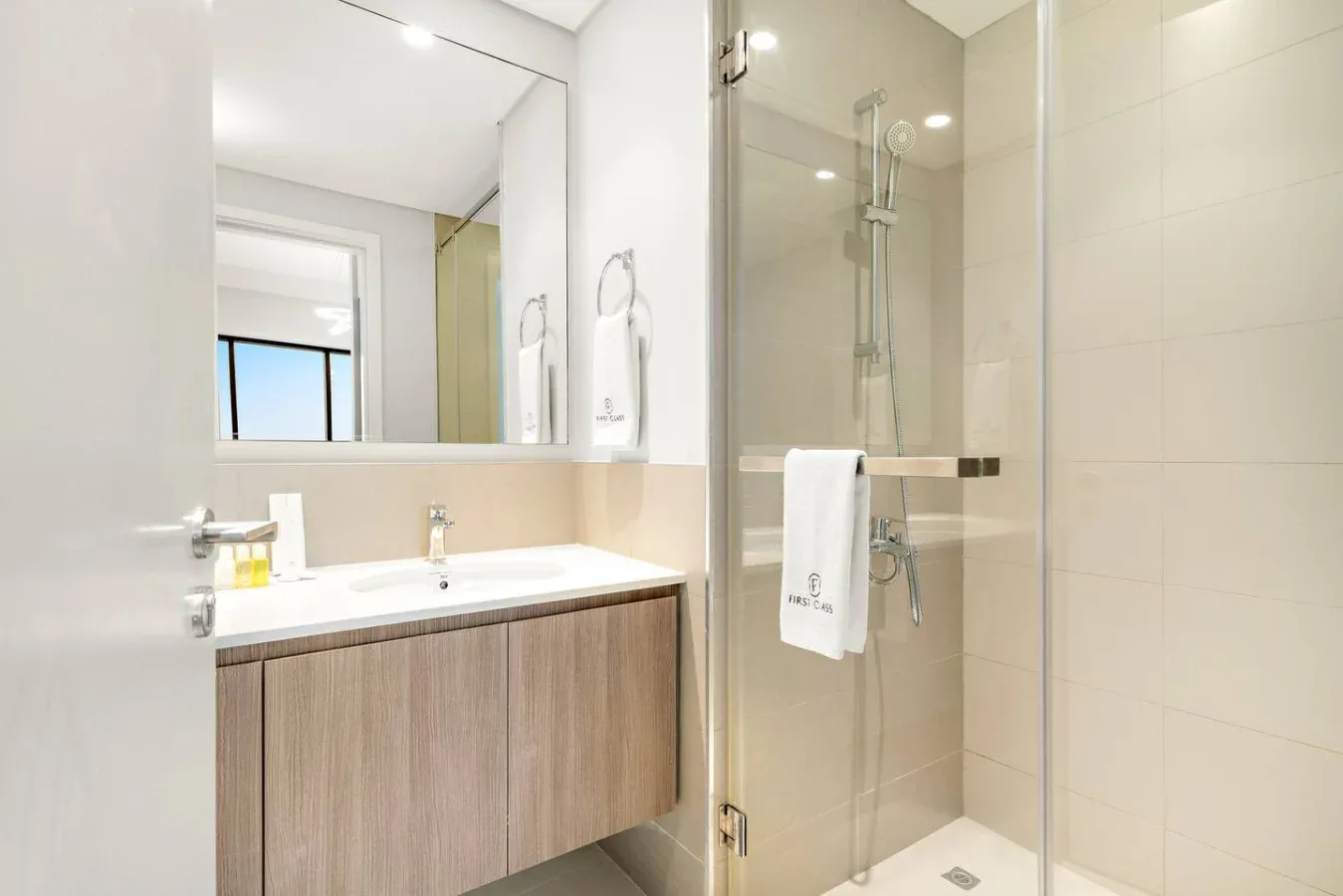 A modern bathroom with a vanity and a glass shower.