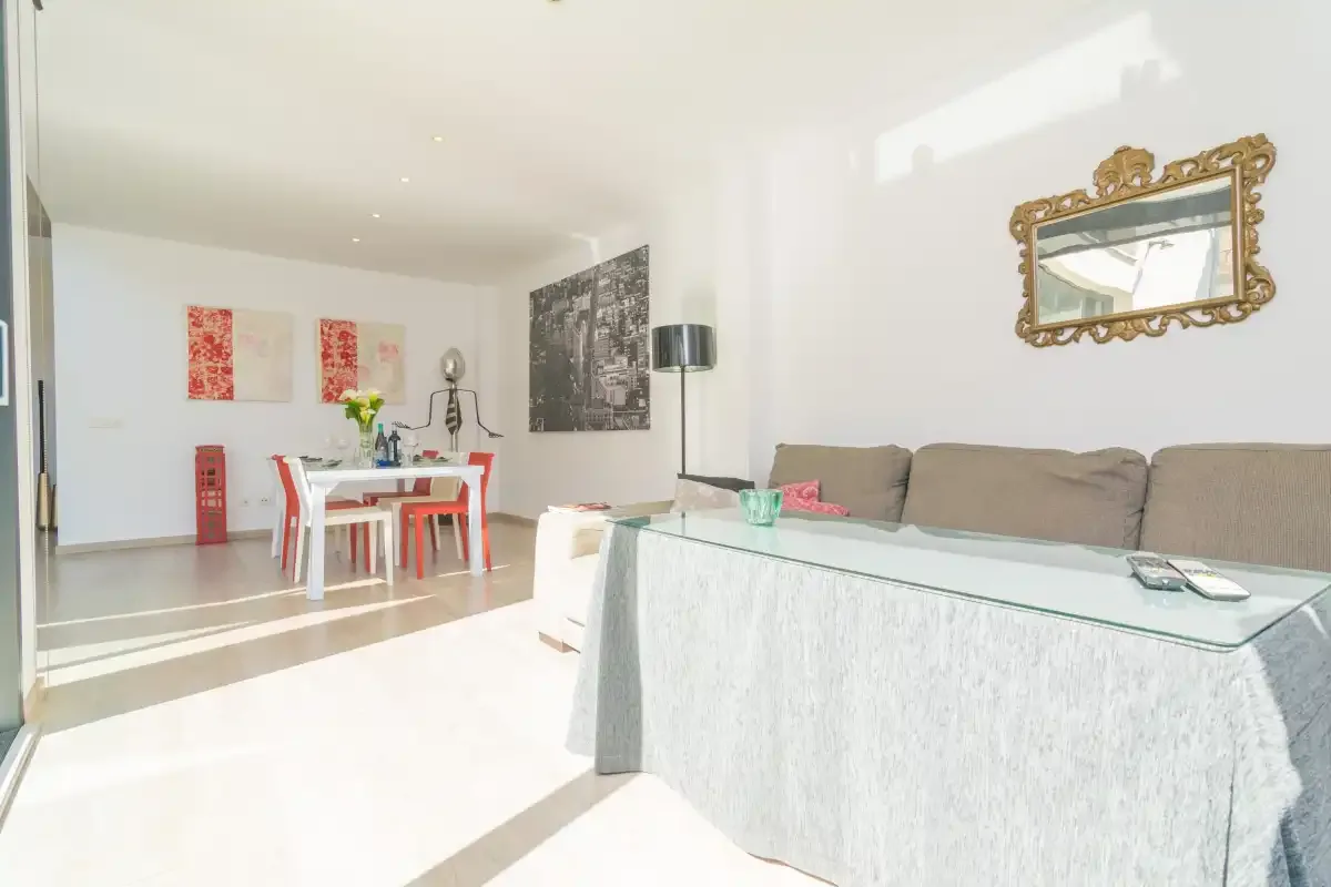 A bright living room with a dining table and seating.