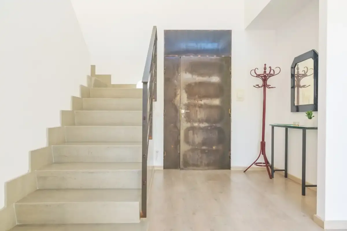 A bright entry hall with a staircase and a console table.