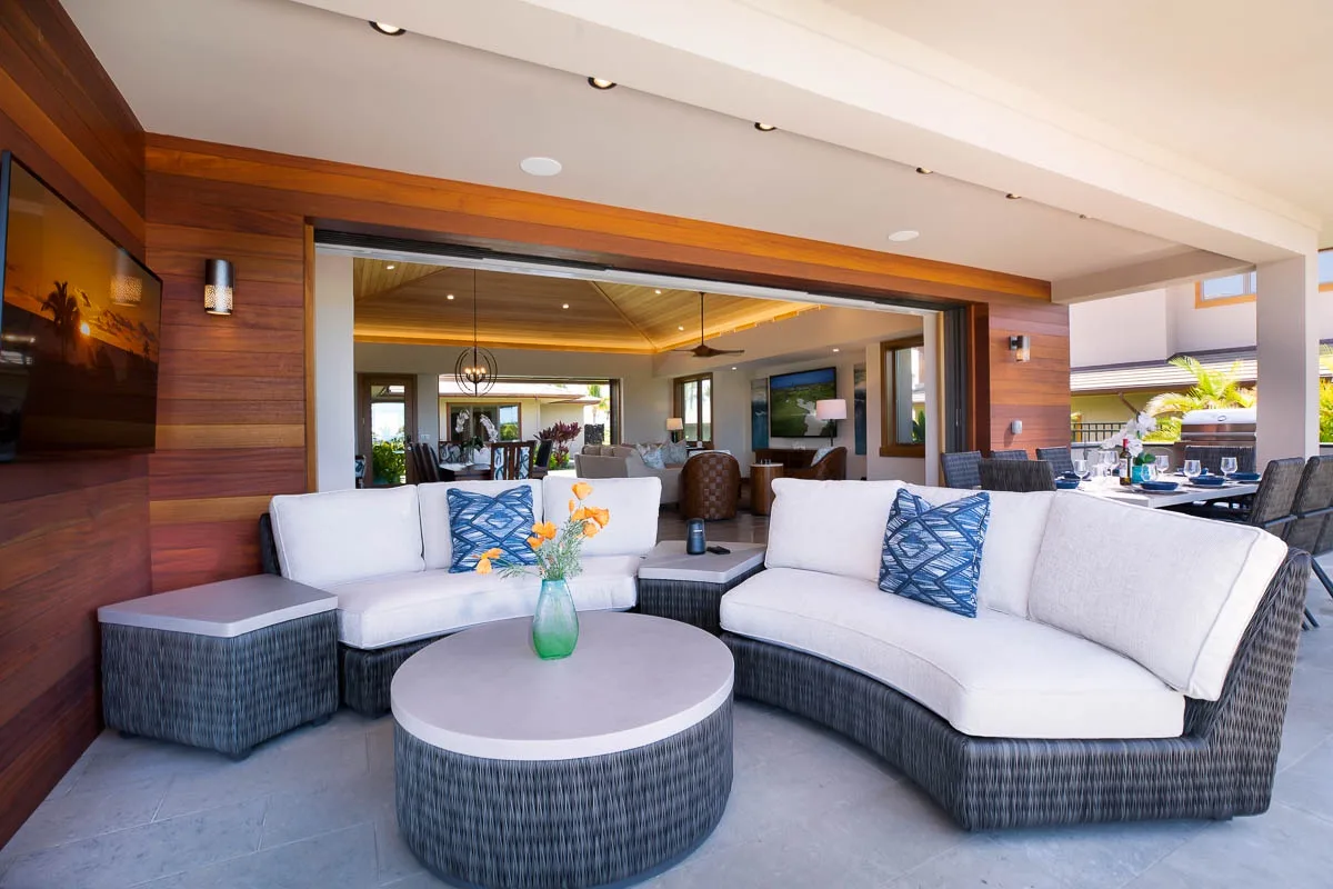 An open-plan lounge with curved seating and a round coffee table.