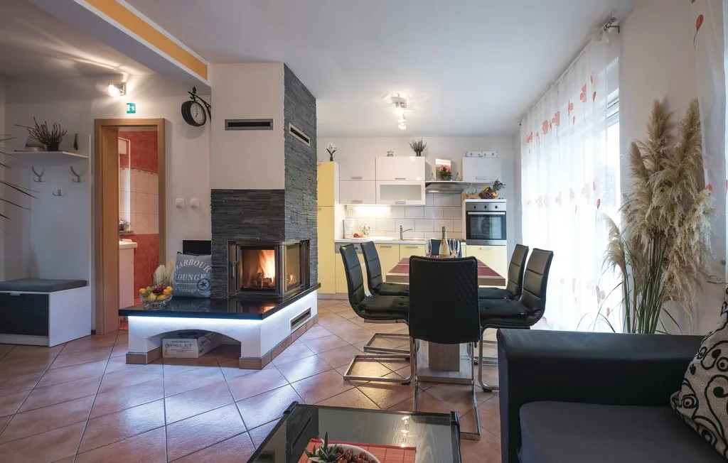A bright living and dining area with a table beside the kitchen.