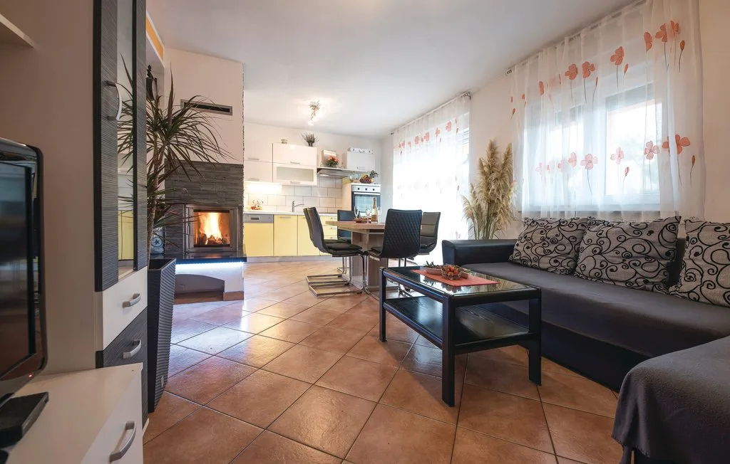 A living room with seating, a coffee table, and a fireplace.