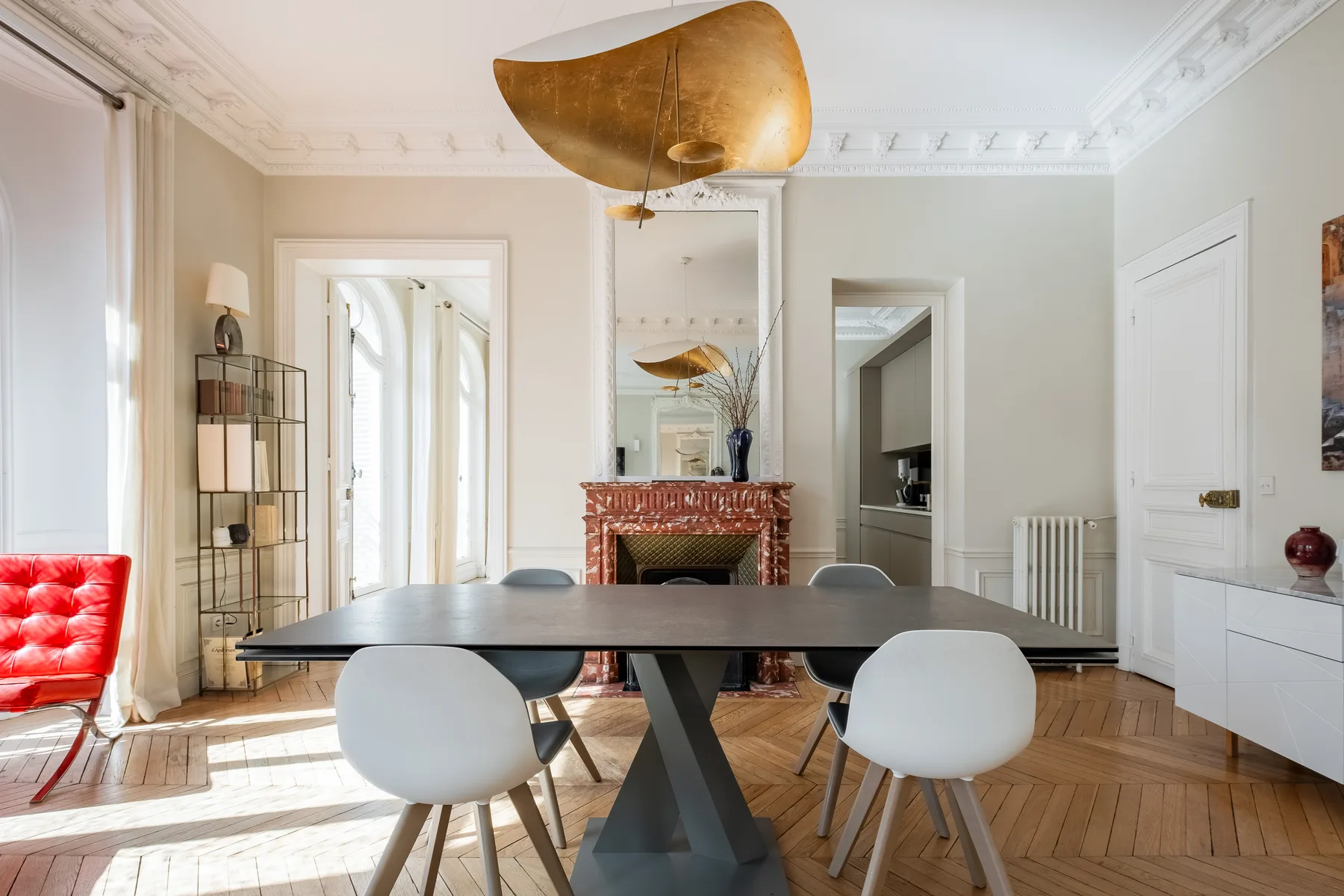 A bright dining room with a table, chairs, and a fireplace.