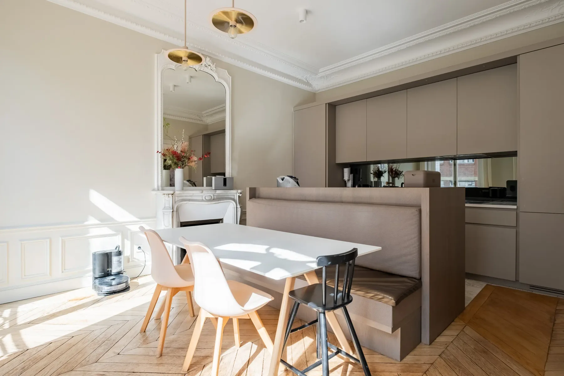 A bright dining area with a table beside a built-in bench.