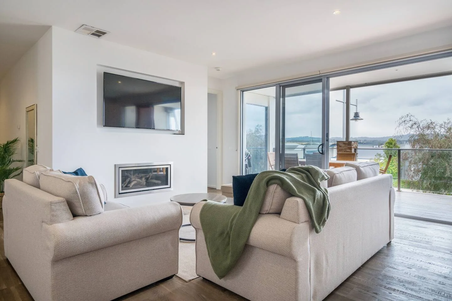 The living room opens to the covered balcony, creating a beautiful transition between the indoors and out.